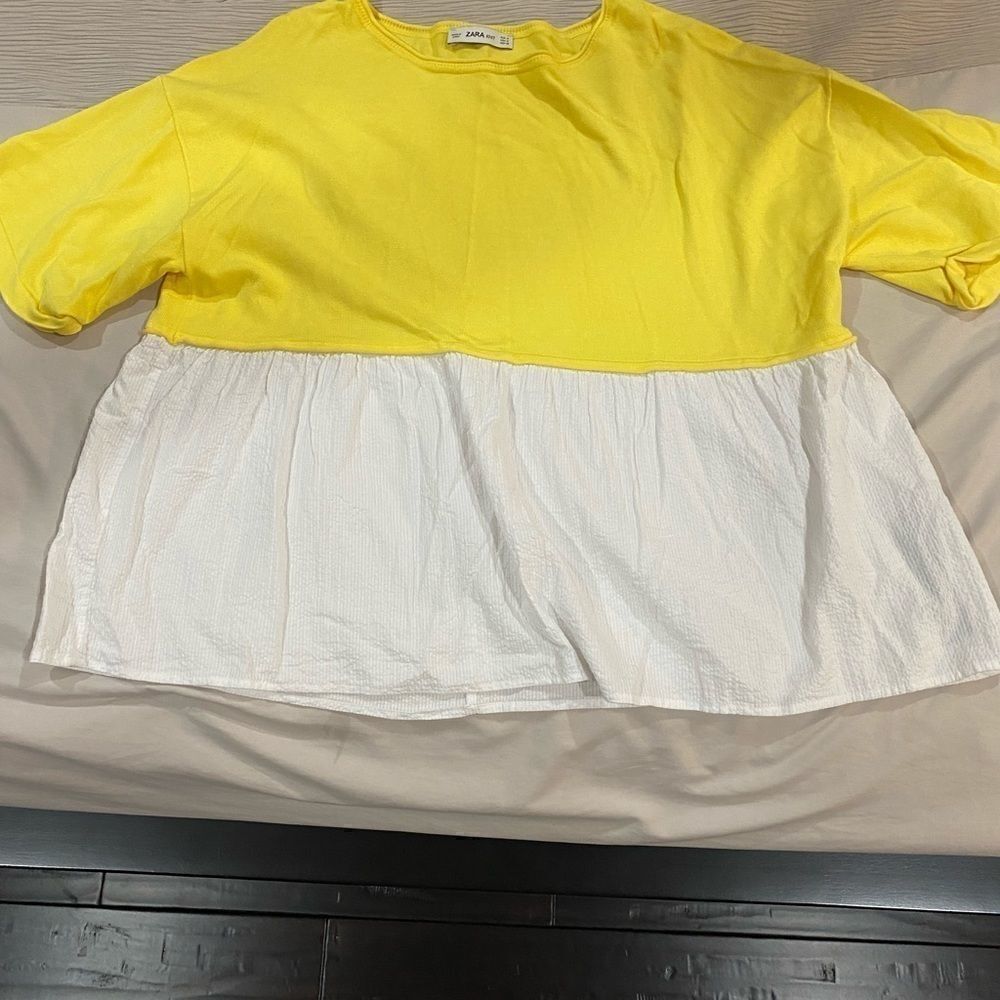 Zara’s yellow/white shirt   